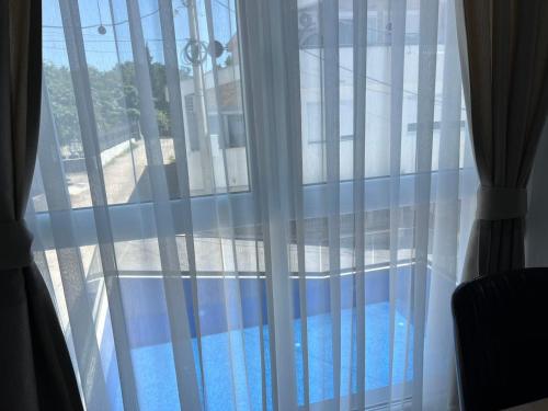 a window with a view of a swimming pool at Relax Apartmani in Sutomore