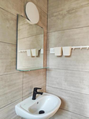 a bathroom with a sink and a mirror at Sea & sun view in Agios Stefanos