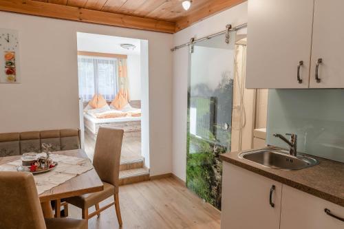 a kitchen and dining room with a table and a room at Sonnentau in Sankt Johann im Pongau