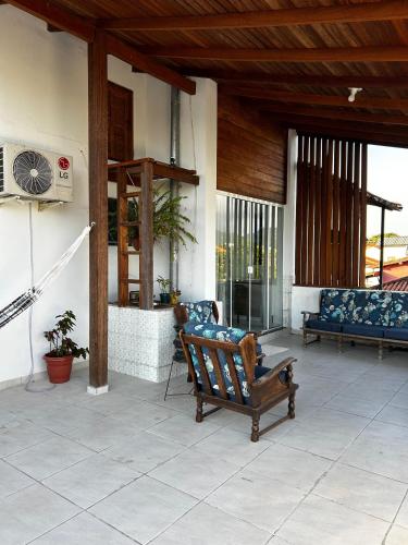 a porch with a bench with a cat sitting on it at Varanda do Campeche in Florianópolis