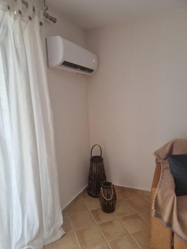 a room with a air conditioner on the wall at Studio Καρπώ Karpo in Galaxidhion