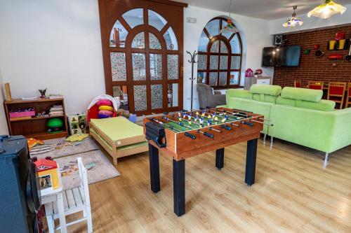 a living room with a chess board on a table at Penzion Karlov in Karlov