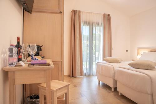 a hotel room with a bed and a table with a bed at MARISTESI in Siniscola