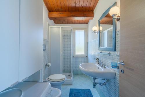 a bathroom with a sink and a toilet and a mirror at Estremo Sud - Marzamemi Candy in Marzamemi