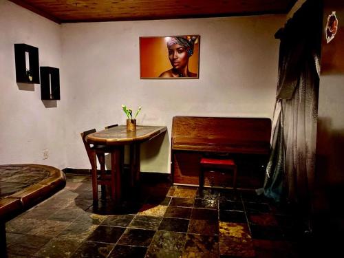 a room with a wooden table and a piano at Horizon Green Guest House in Randfontein