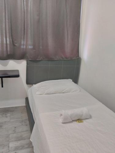 Uma cama ou camas num quarto em Hotel Ozzy
