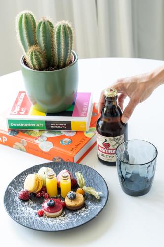 a plate of food on a table next to a cactus at INNSiDE by Meliá Hamburg Hafen in Hamburg