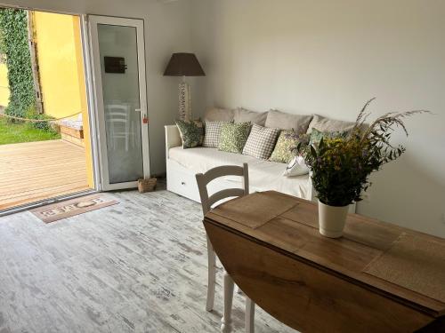 a living room with a table and a couch at La Cabane Lacourrège in Urgosse