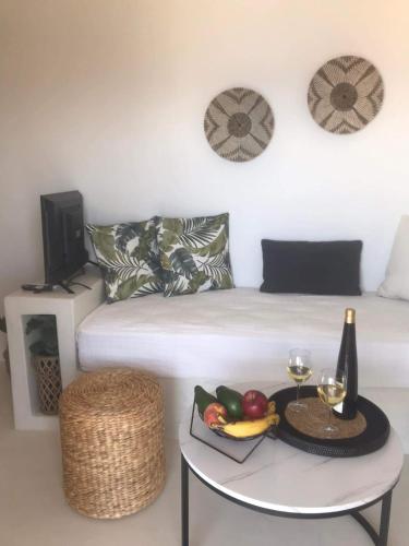 a room with a bed with a tray of fruit on a table at Darsi suites Kythnos in Kithnos