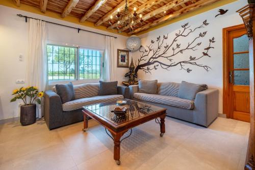 a living room with two couches and a coffee table at Villa Can Cardona in Montecristo