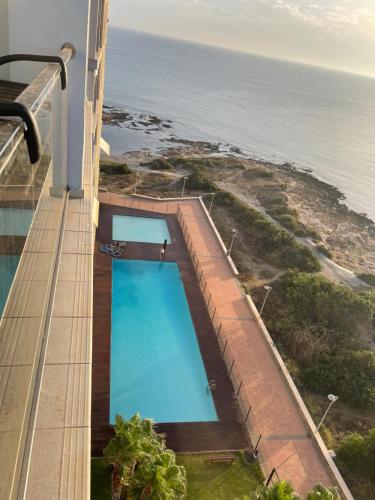 an overhead view of a swimming pool on a building overlooking the ocean at Encanto del Mar La manga, Sea View in San Blas