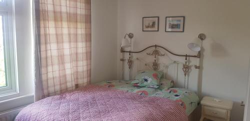 a small bedroom with a bed in a room at Compton Guest House in London