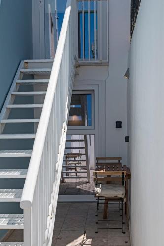 a stairway with a bench and a stair case at Chalet Marias - Parede beach apartments in Parede