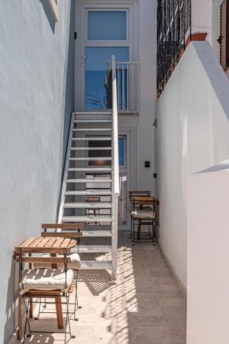 a patio with a staircase and tables and chairs at Chalet Marias - Parede beach apartments in Parede