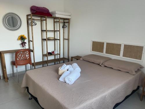 a bedroom with a bed with towels on it at Vila Girassol in Aracaju