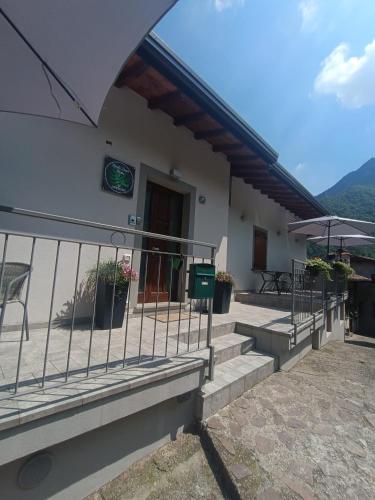 a building with stairs and a fence in front of it at Monte Zucco Relax self check in in San Pellegrino Terme