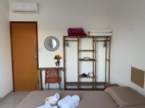 a room with a bed and a ladder and a table at Vila Girassol in Aracaju
