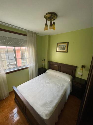 a bedroom with a bed and a ceiling fan at mar azul in Malpica