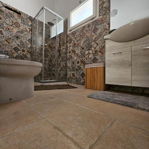 a bathroom with a toilet and a sink at Salenzia apartment in San Cesario di Lecce