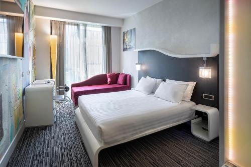 En eller flere senge i et værelse på Best Western Premier Hotel Royal Santina