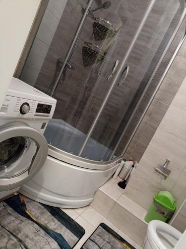 a bathroom with a shower with a toilet and a shower at квартира в ЦО Радуга Иссык Куль9 Raduga Issyk Kul in Chon-Sary-Oy