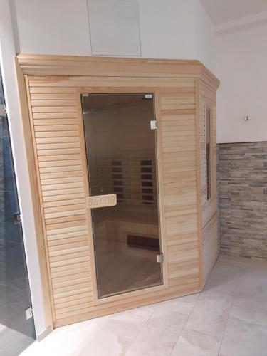 a large wooden door in a room at Residence Aurora Wellness & Spa in Albenga