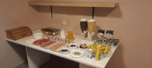 a table with food and drinks on a counter at City Hotel Bucharest in Bucharest