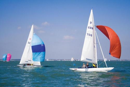 two sailboats in the water with people on them at Valetta Park in Emsworth