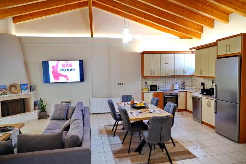 a kitchen and a living room with a couch and a table at ΑμφιΘΕΑ! στη ΝΑΥΠΑΚΤΟ ! in Nafpaktos