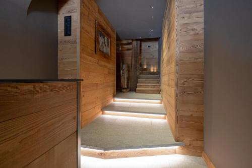 a hallway with wooden walls and a television at Grande Cote Room and Breakfast in Cesana Torinese