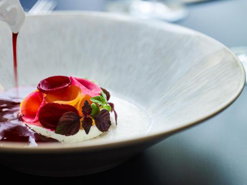a white plate with a dessert on a table at Sofitel Frankfurt Opera in Frankfurt/Main
