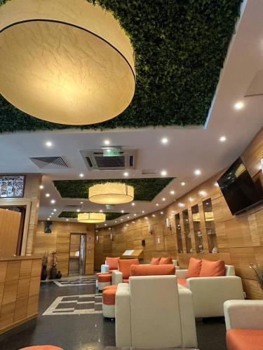 a lobby with couches and chairs in a building at Briz Beach apartments - section B in Sunny Beach