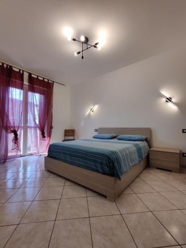 a bedroom with a bed in a room with windows at Cerro Flat in Cerro Maggiore