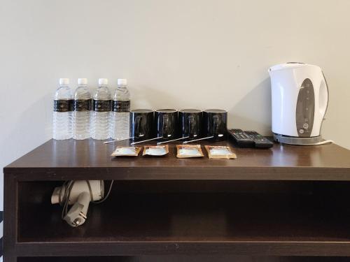 a table with bottles of water and a toaster at Izumi Hotel Bukit Bintang Kuala Lumpur in Kuala Lumpur