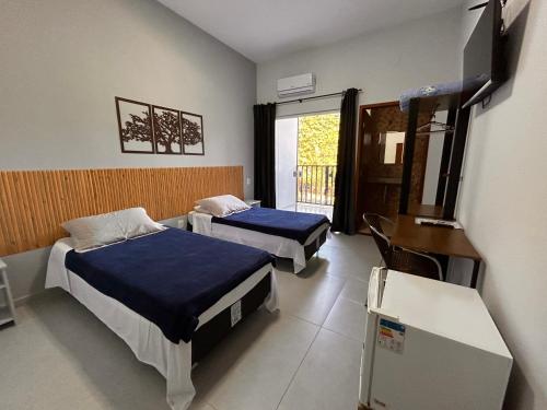 a hospital room with two beds and a window at Pousada Dona Francisca in Florianópolis