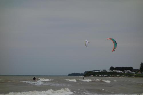 two people are kite surfing in the water at Strandhaus direkt am Meer in Haderslev