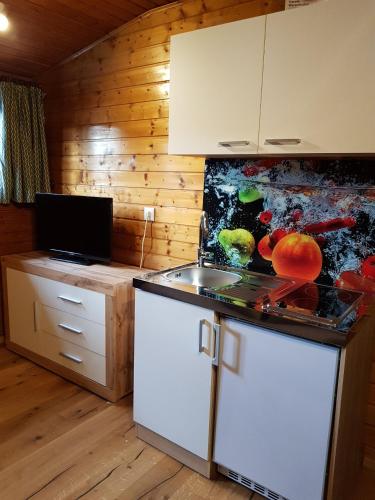a kitchen with a sink and a counter top at Der Kristall by Globalimmoservice in Bad Kleinkirchheim