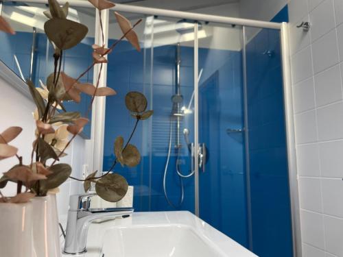 a bathroom with a shower and a white sink at Garda Golf Studio in Soiano del Lago