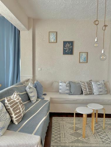 a living room with a couch and a table at Iris Sunset View Home in Samos