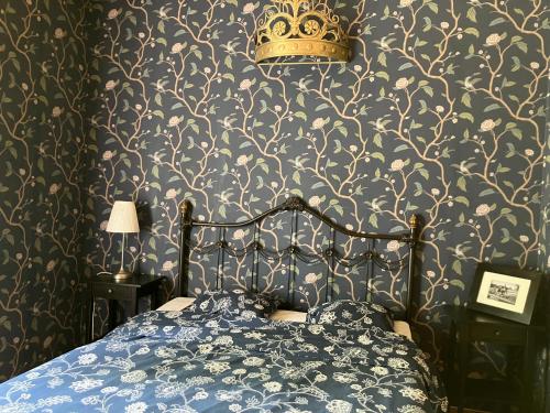 a bedroom with a bed with a crown on the wall at VILLA ANNA in Naantali