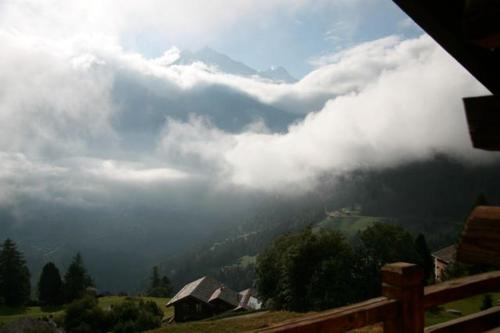 a view of a mountain with clouds in the sky at Chalet Alouette in Grimentz