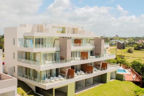 een appartementencomplex met een balkon en een zwembad bij Zelena Voda in Villa Gesell