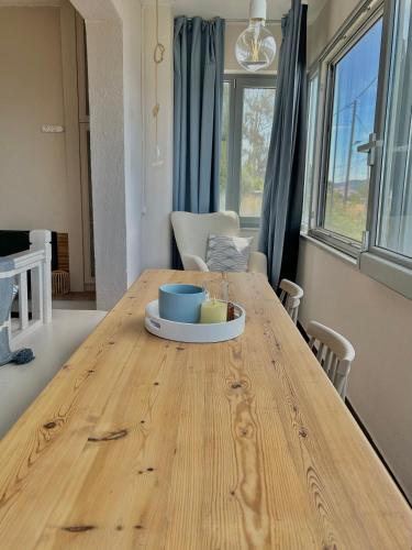 a wooden table with a bowl of food on top of it at Iris Sunset View Home in Samos