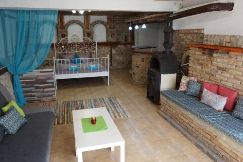 a living room with a couch and a stove at Forest house in Varna City