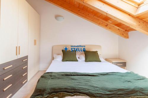 a bedroom with a large bed in a room with wooden ceilings at Ville Martellozzo in Lido di Jesolo