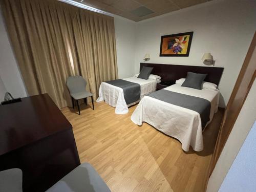 Postel nebo postele na pokoji v ubytování Hotel Constitución