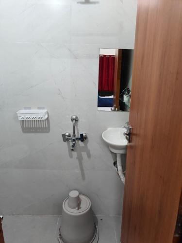 a bathroom with a toilet and a sink at Mahadev Mansion in Ujjain