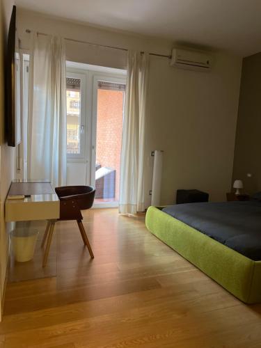 a bedroom with a bed and a desk and a window at Acquedotto the house in Rome