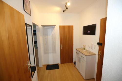 a small bathroom with a sink and a refrigerator at Ferienwohnung Sölkner in Tauplitz