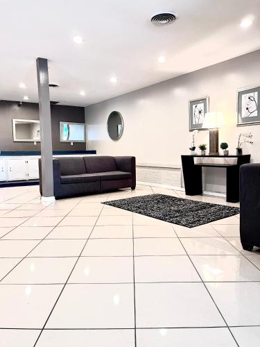 a living room with a couch and a table at APM Inn & Suites in Martinsburg